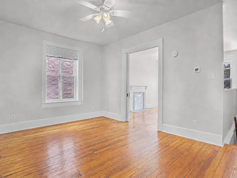 Living room, high ceilings, looking into the bedroom, front door down the stairs on the right.