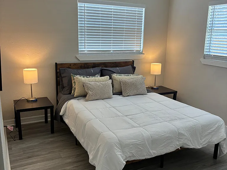 Cozy, warmly lit bedroom with a relaxed and homey atmosphere.
