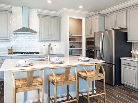Centrally located in the home, the kitchen features a center island with granite countertops perfect