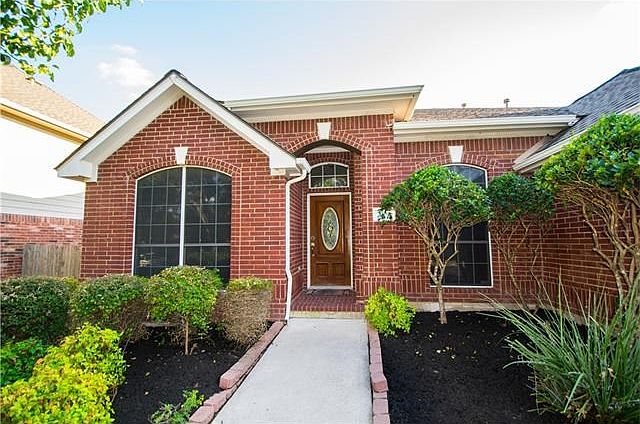 Front of the house with beautifully landscaped frontyard