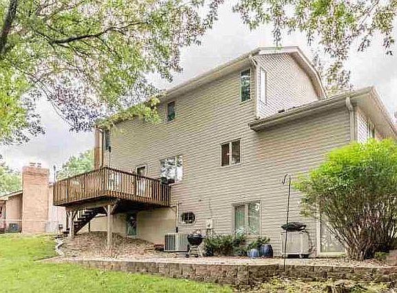 Two outdoor seating areas - deck off the family room and large paved patio