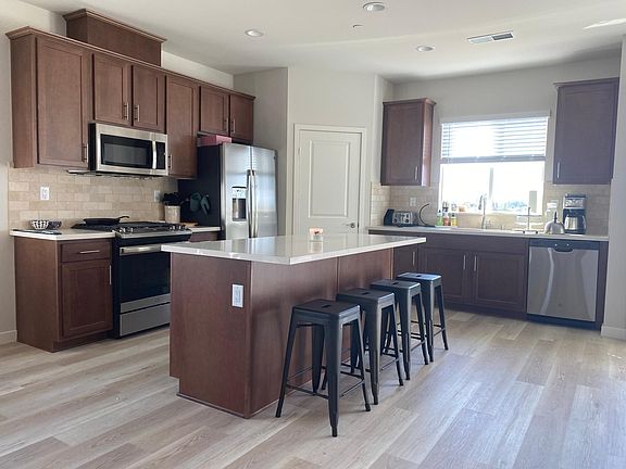 Kitchen with GE appliances including refrigerator. Walk-in pantry, kitchen island (stools and countertop items not included).
