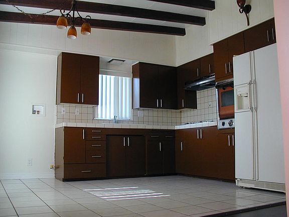 Kitchen includes refrigerator, stainless steel stove & separ