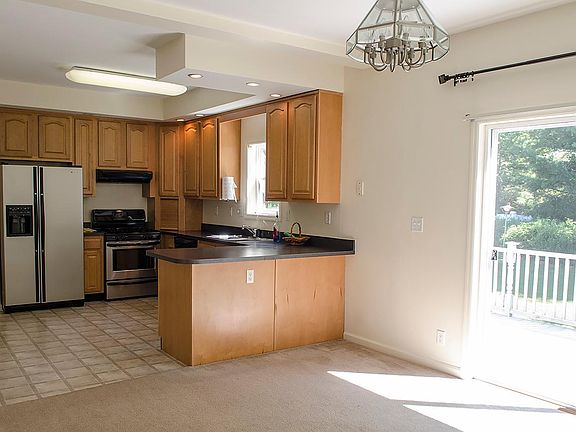 Kitchen, viewed from dining room, w doors to back deck