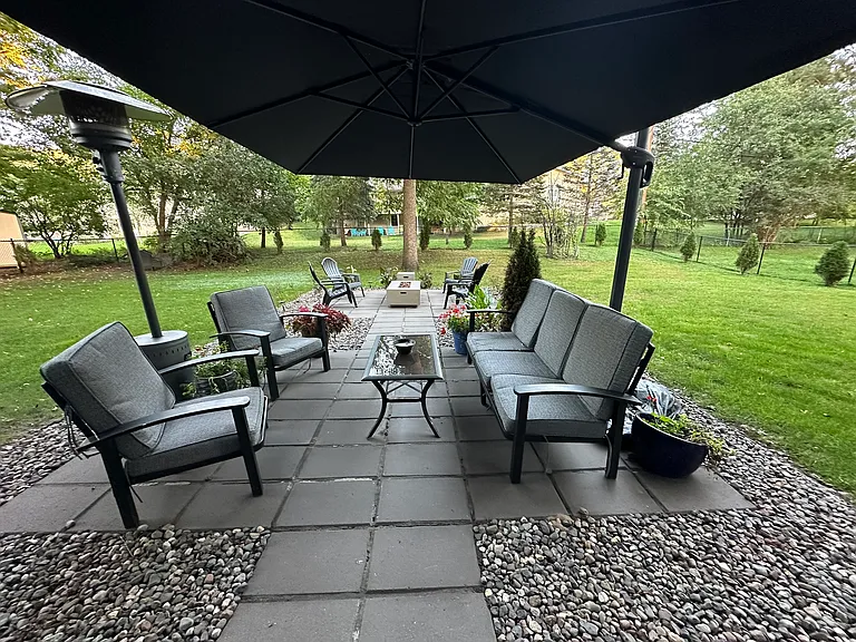 Landscaped patio pavers provide intimate outdoor gathering spaces.