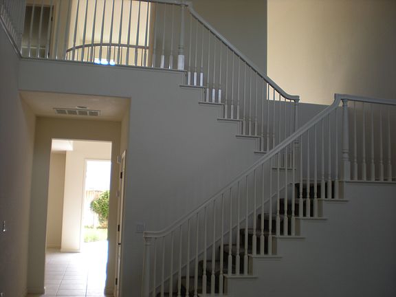 Stairway with open views to first floor.