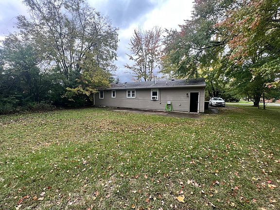 Back of house with large yard