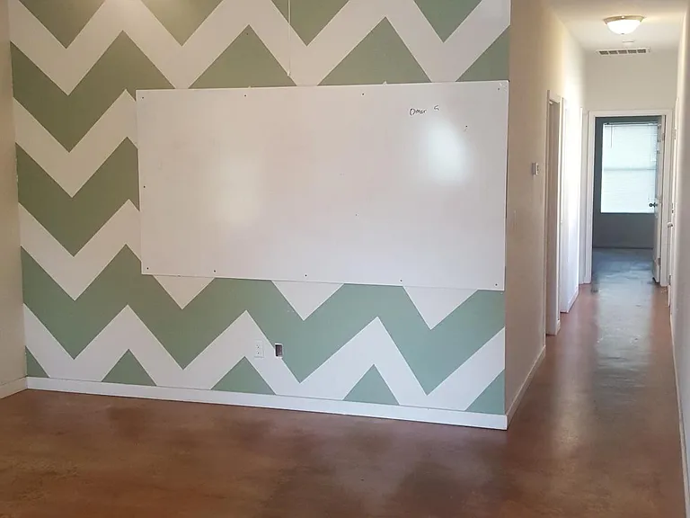 Walls being painted to remove pattern wall.
