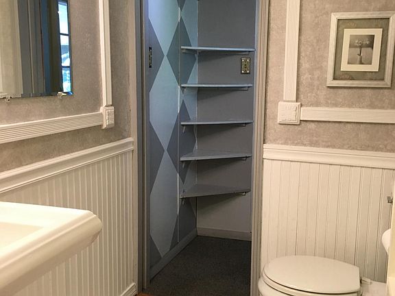 Small pantry area between kitchen and bathroom, pocket door 