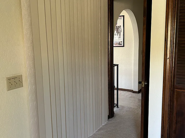 Additional vertical blinds give this bedroom additional privacy.