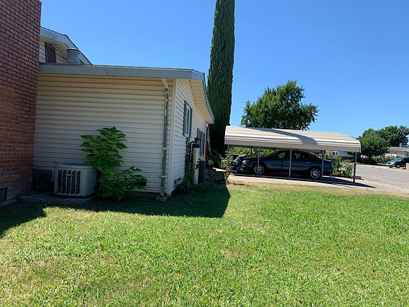 Side of house and two car carport