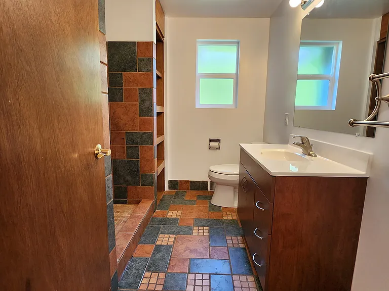 3/4 bathroom with large shower and a Northwest x Southwest flair in tiling.