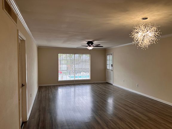 The living room windows boast a view of the second pool and a glimpse of the main pool farther up the driveway. Enjoy plenty of light from these north-facing windows while remaining cozily out of the direct sun.