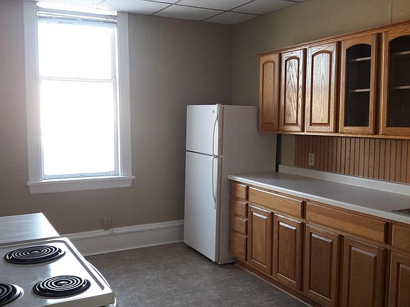 From living room to kitchen. bathroom to right. bedroom across from refrigerator.