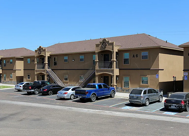 Merida Vista Apartments in Laredo, TX - Exterior Building Apartment A6 and C with Parked Cars along with Exterior Stairs