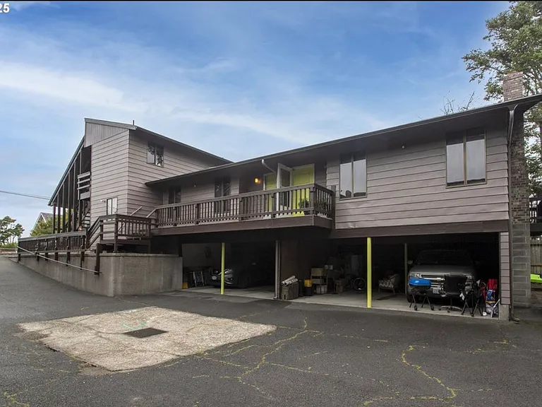 Parking directly below, with a large storage unit behind. Laundry area behind the parking.