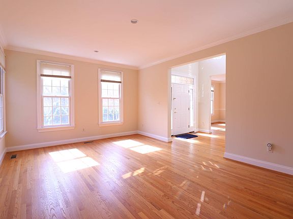 Living Room on main floor has windows with views of the front and side yards