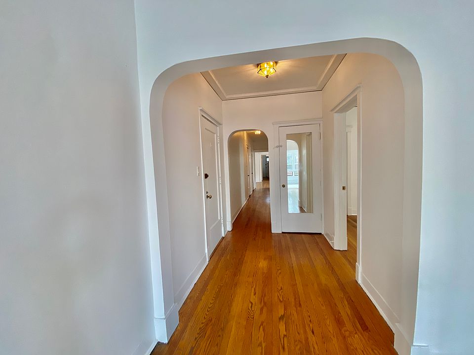 Hallway with beautiful archway leads to 3 BRs/2BAs, 2 massive walk-in closets and back formal DR, KIT and back private deck