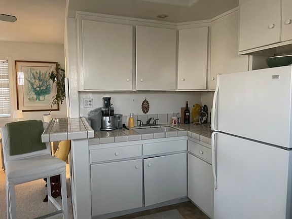 Kitchenette with sink, microwave, refrigerator and plenty of cabinet space