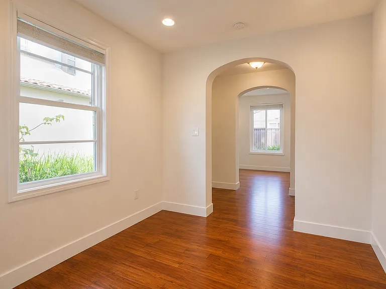 Bright first-floor living room with elegant archways and abundant natural light