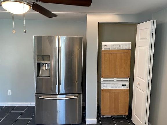 Large Samsung refrigerator + Stack-able washer dryer closet
