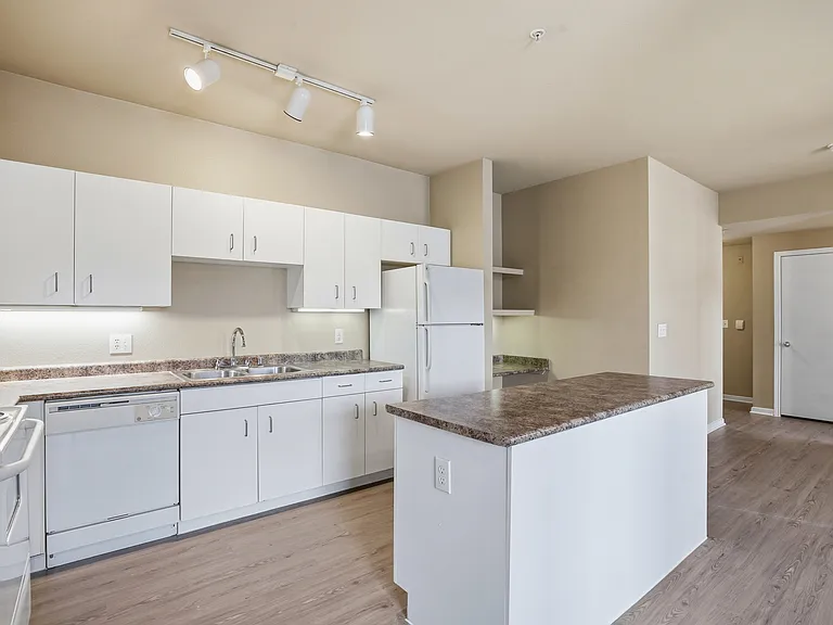 Classic Kitchen with granite countertops with white appliances with great storage.
