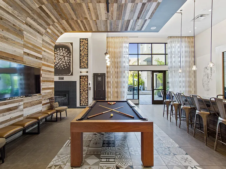 Common Area with Pool Table, Kitchen and Seating at Aventine Apartments in Hercules, CA 94547