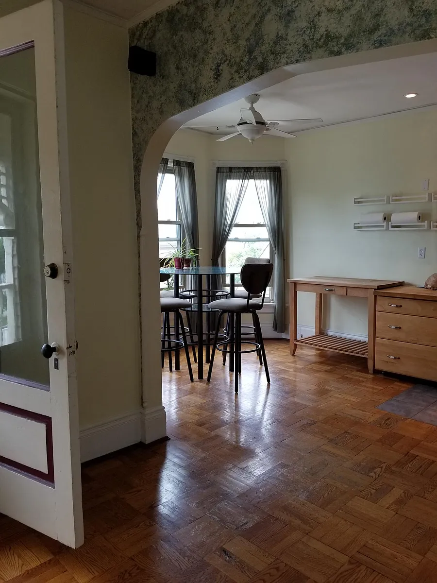 Dining room view from the living room. Balcony door to 3' x 8'. Dining room table & chairs included. - 1562 E Irving Pl