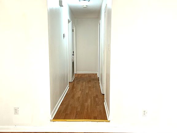 Hallway leads to full bathroom, bedrooms and master suite.