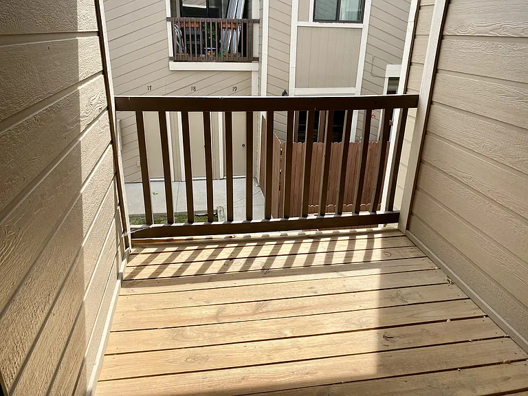 Private balcony facing east, overlooking the shared yard.