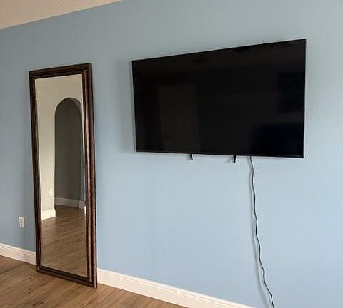 55" smart TV and 6' standing mi