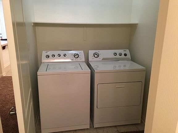Indoor utility closet includes washer and dryer