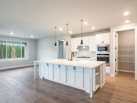 Kitchen opens to gathering room and cafe space