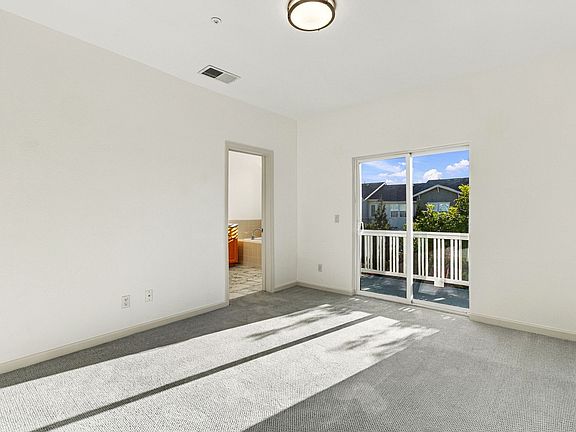 Spacious primary suite with private balcony and direct access to the primary bath.