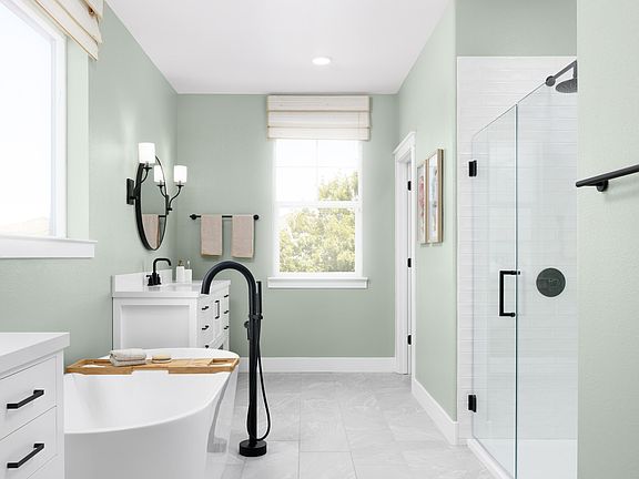 Glass shower enclosure with stylish tile and matte black fixtures