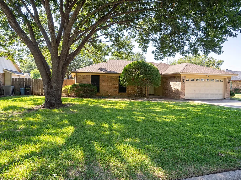 Large front yard with shade tree.