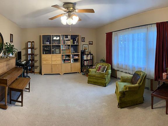 Spacious living room with large picture window and two single side windows. Brings in lots of sun.