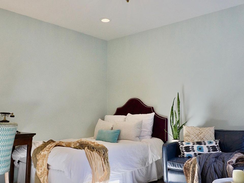 Main room -- plenty of room for your bed. Crystal chandelier provides great, textured lighting. Pictured here is a full size bed. Wall is over 13 feet.