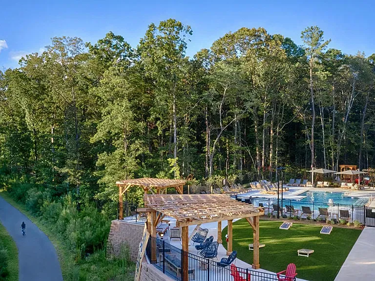 Scenic Pool and Outdoor Lounge Overlooking Nearby Forest and Walking Trail