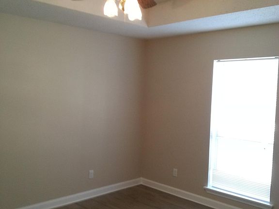 Master bedroom with new ceiling fan and newly installed wood