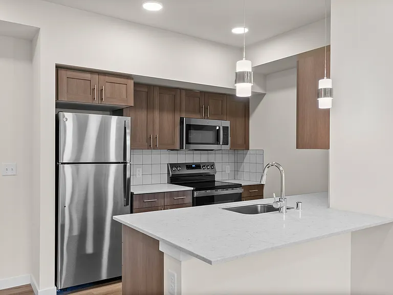 A contemporary kitchen design with sleek finishes and plenty of counter space. A contemporary kitchen design with sleek finishes and plenty of counter space.