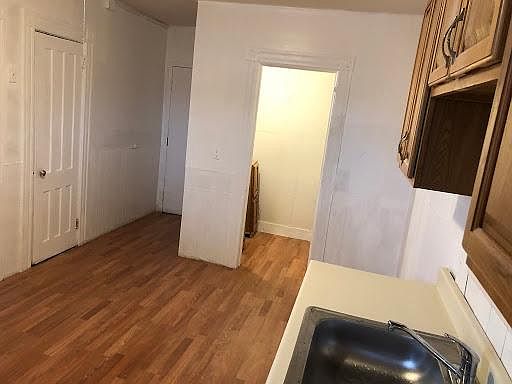 Kitchen and pantry. New cabinets & sink! New wood Floor!