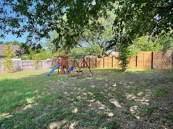 Flat backyard can accommodate playscape (not included)
