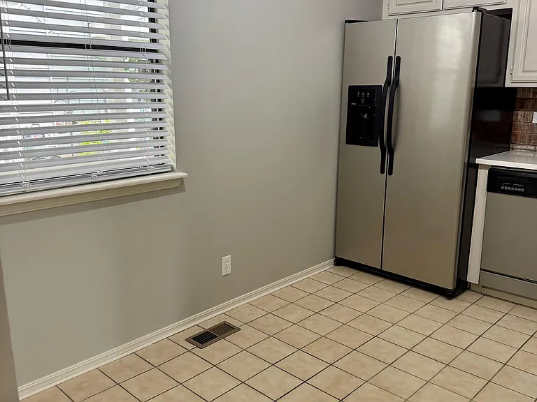 Newly renovated kitchen with quartz countertops and exposed brick