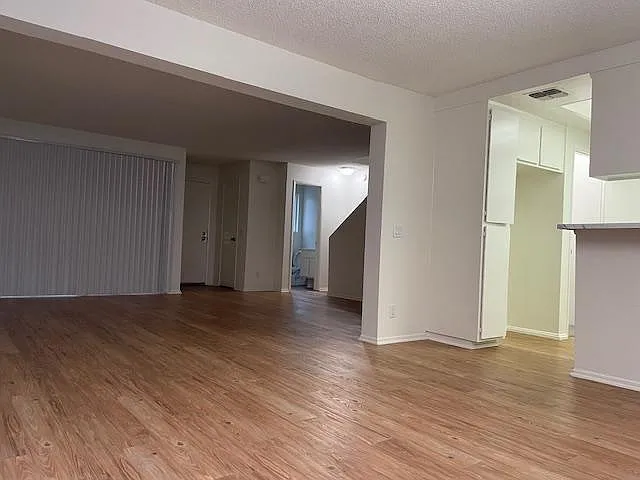 From Dining Room looking to Living Room. Half bath at base of stairs.