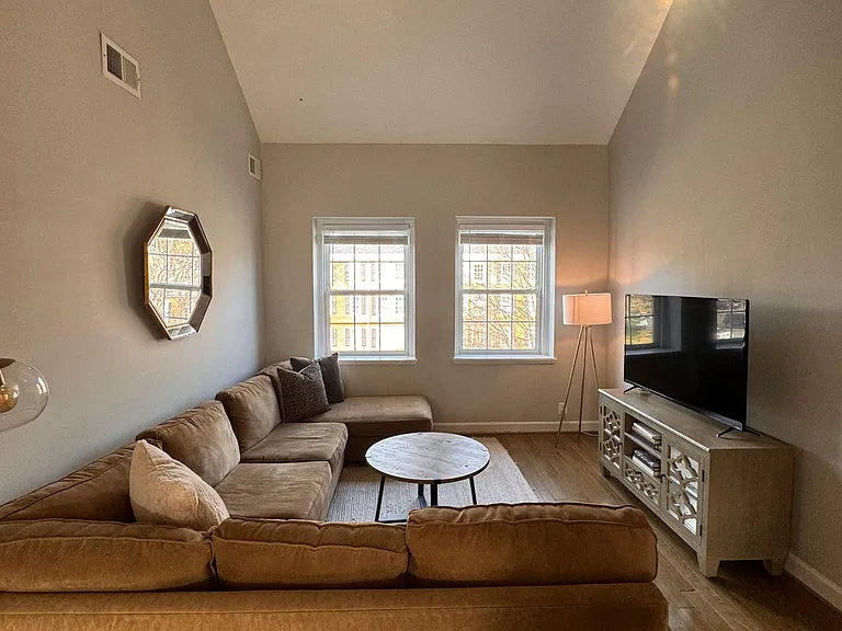Light-filled Living rm with cathedral ceiling