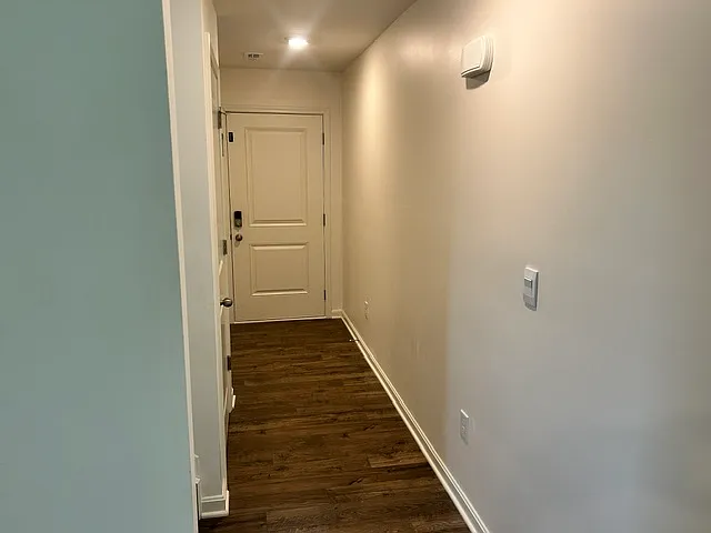 front entry hallway with half bath and closet to the left