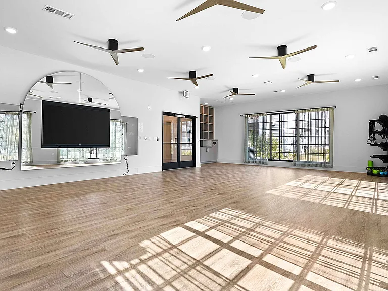 Experience the elegance of this expansive gym studio with its modern design and ample natural light.