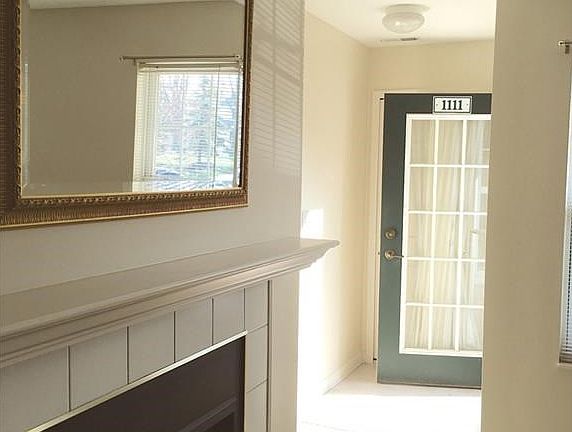 A view of the foyer which includes a convenient coat closet.