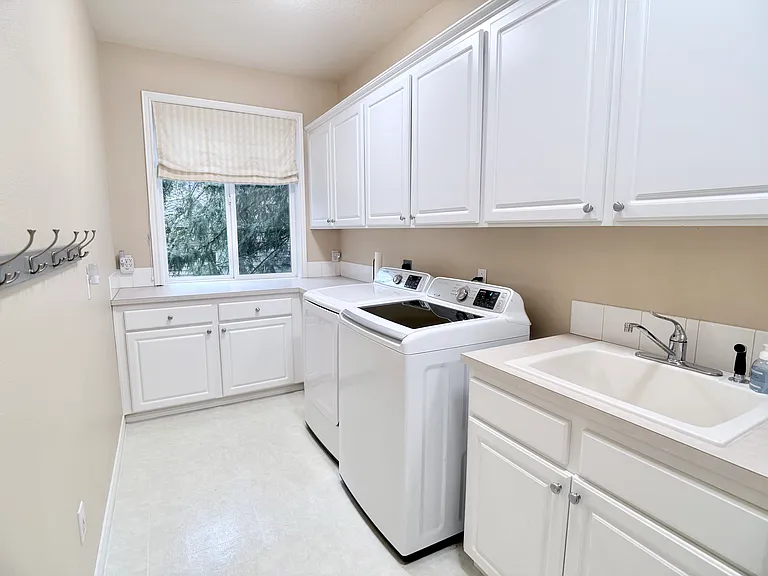 Rear view of the laundry room highlighting the dedicated laundry area with ample counter space for folding and organization.